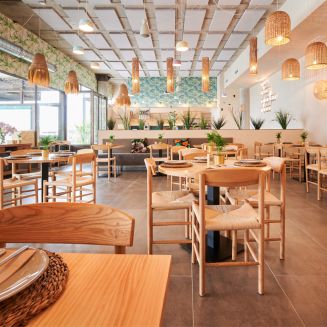 empty rustic design restaurant with wooden furniture and some decorative plants